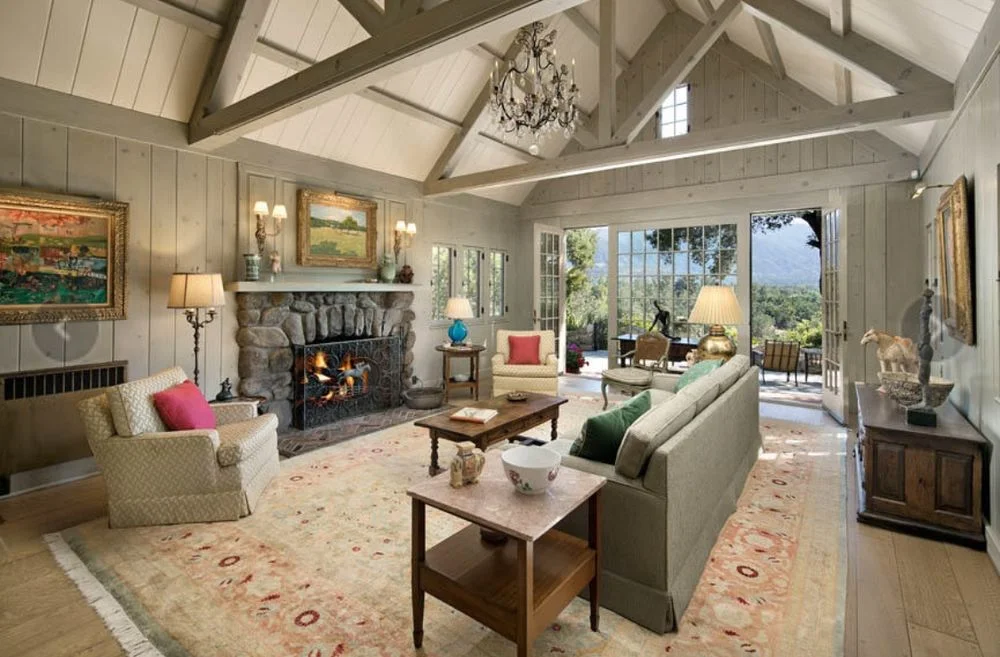 Knotty pine living room repainted to a light modern finish — after