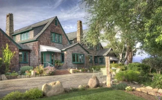 Shingle-style home exterior repainted from dark brown to warm gray — before