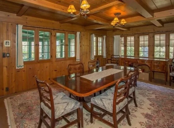 Knotty pine dining room repainted to a light whitewashed finish — before