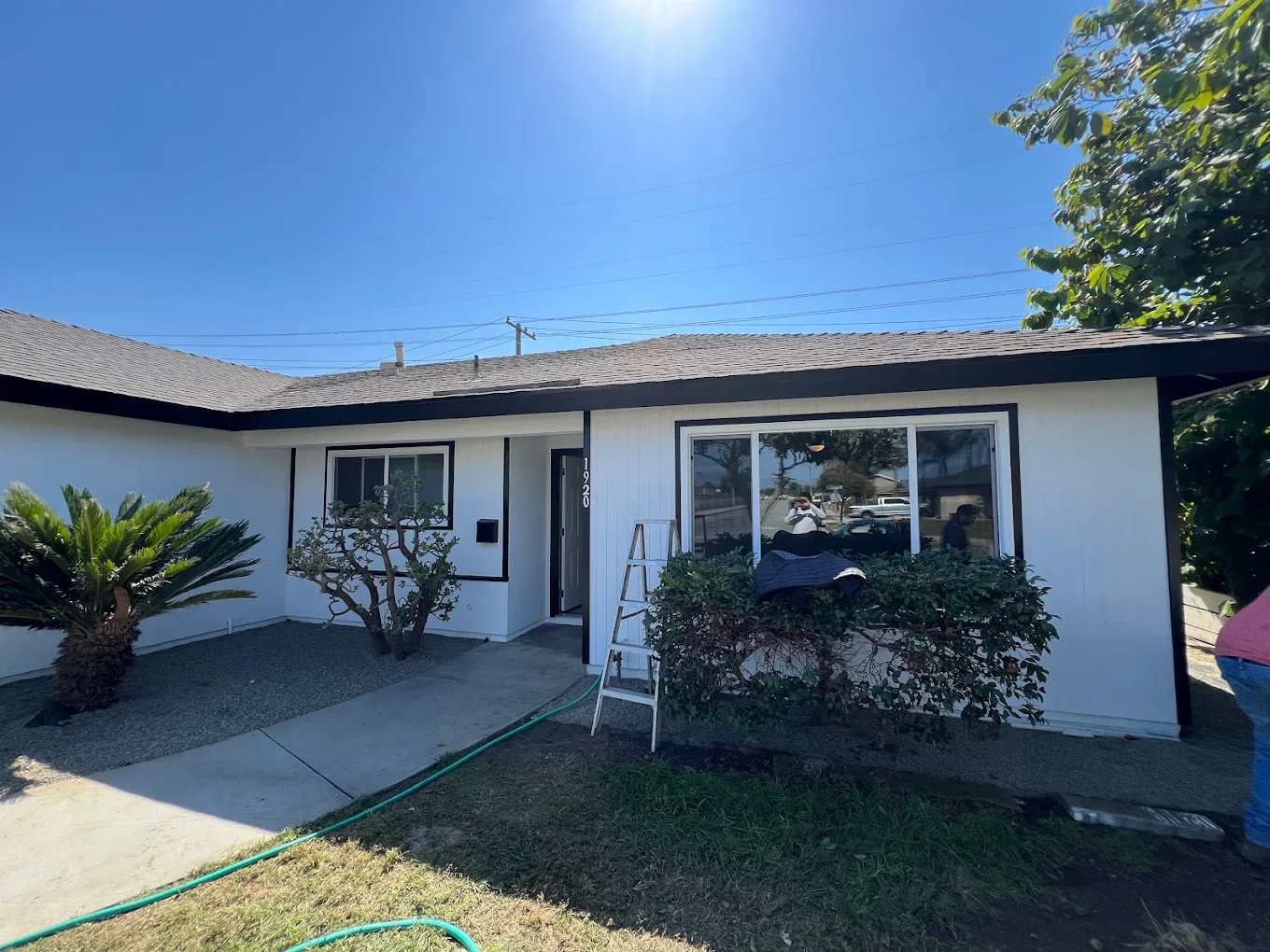 Ranch house exterior with white body and dark trim