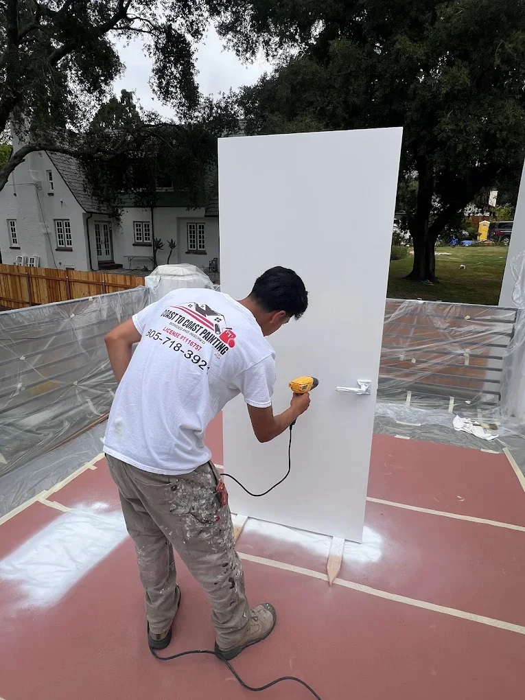Coast To Coast Painting crew member assembling a door panel on site