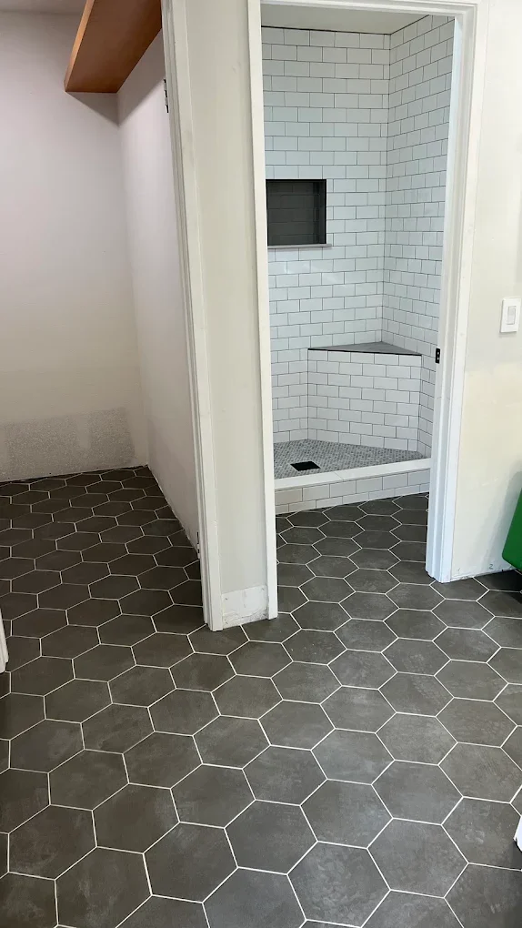 Bathroom with hexagon floor tile and subway-tile shower