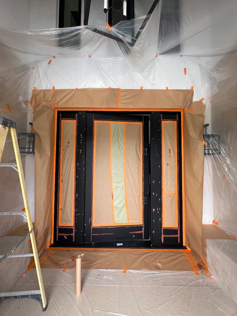 Door and window frame masked with kraft paper for painting