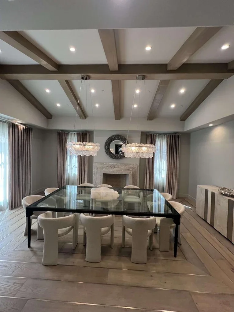 Dining room with wood beam ceiling and marble fireplace
