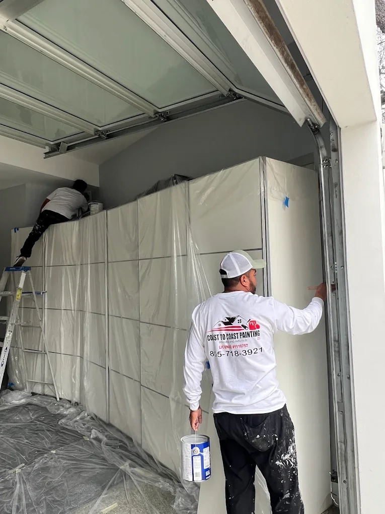 Coast To Coast Painting crew painting a garage interior white