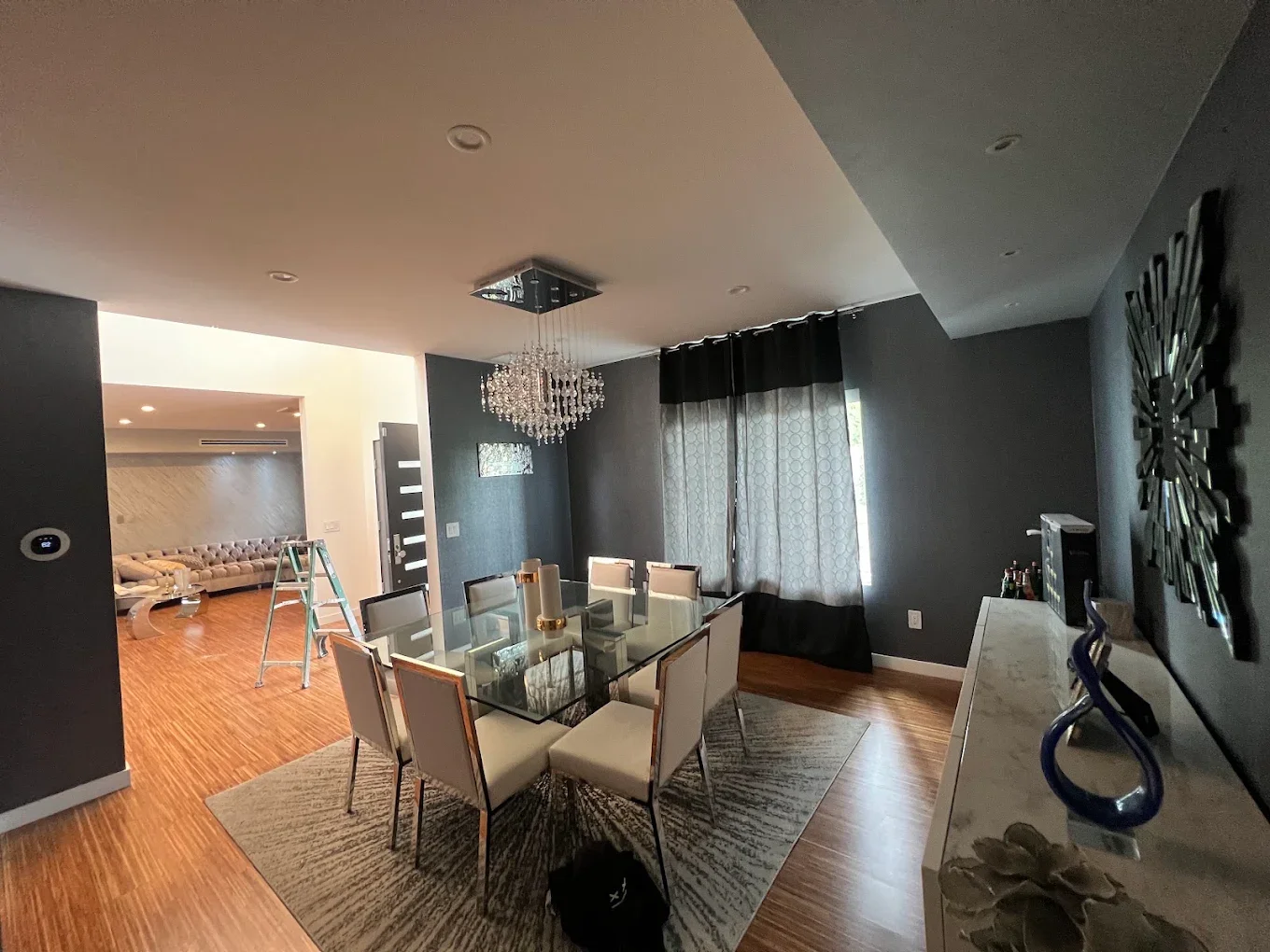 Dining room with dramatic dark charcoal walls, mid-project