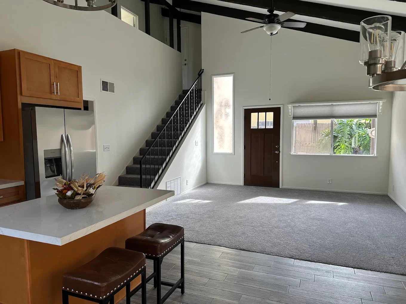 Open kitchen and living area with black beam ceiling